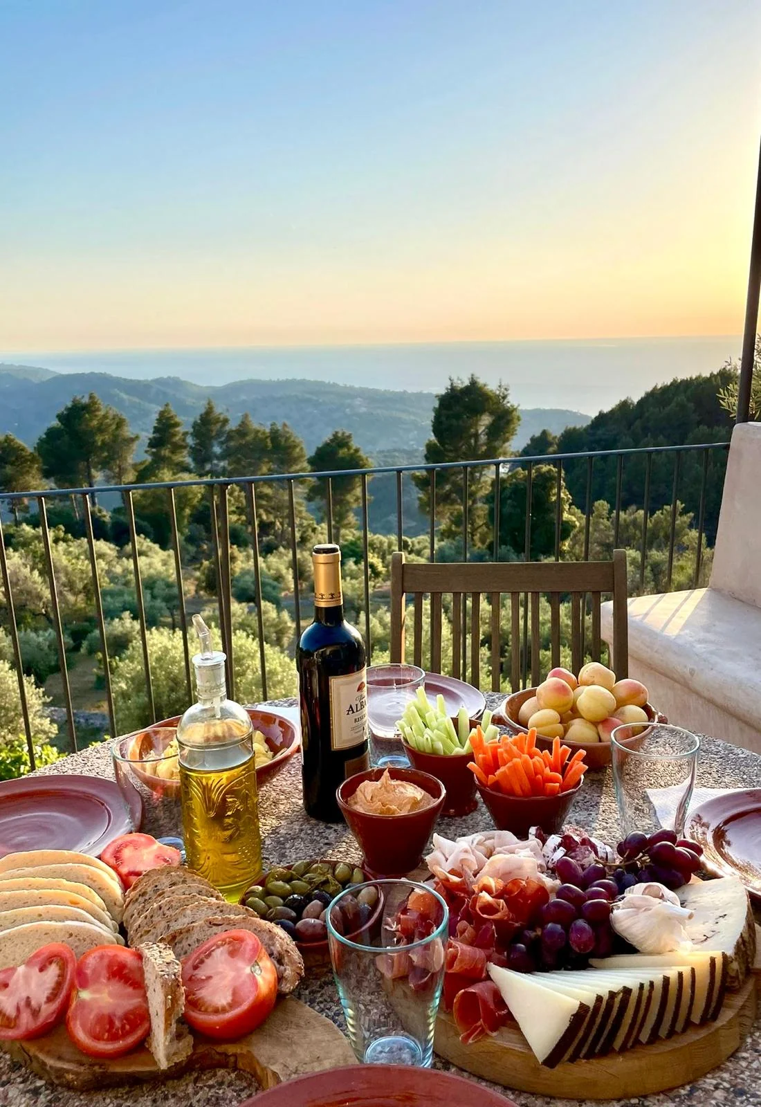 Mediterranean table with olive oil, bread, cheese, fruit and local products
